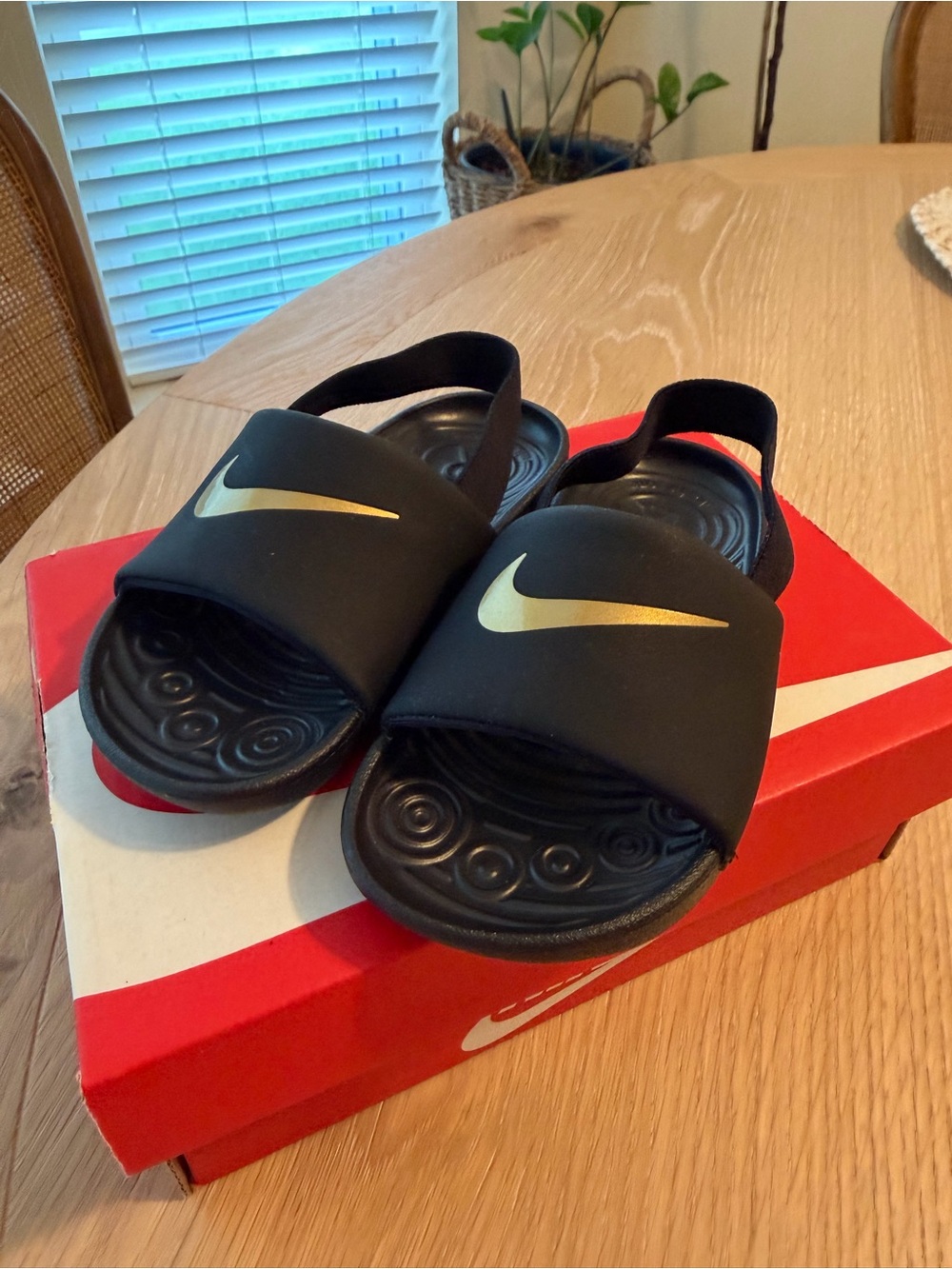 Nike Kids Black Slides with Gold Swoosh and Heel Strap